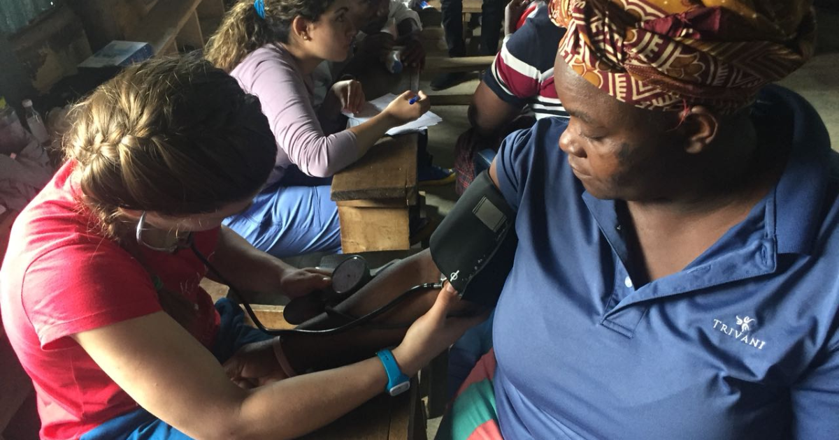 Doctor checking a woman’s blood pressure during CRK-NGO medical campaign in Mathare slum