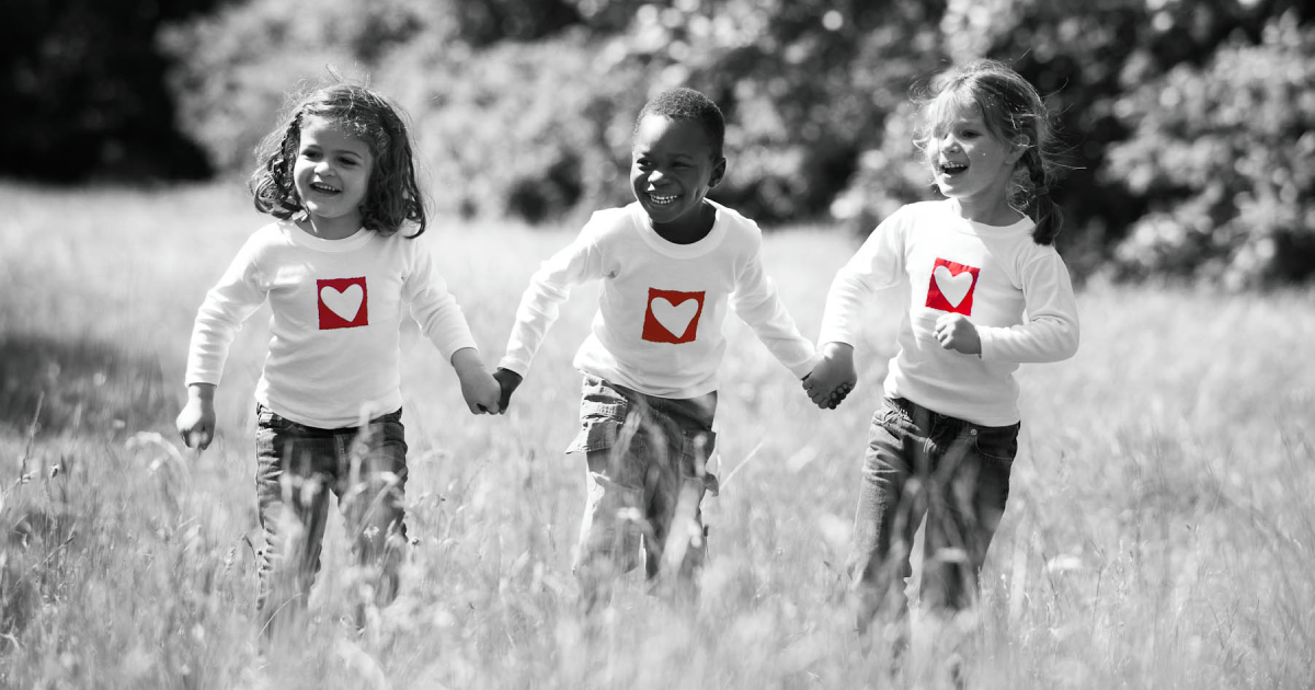 Three children running and holding hands, symbolizing hope after life-saving heart surgery