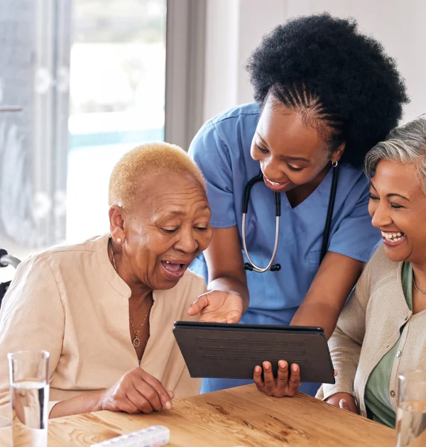 Nurse engaging elderly women with digital health education in Kenya, promoting trust and community healthcare empowerment.